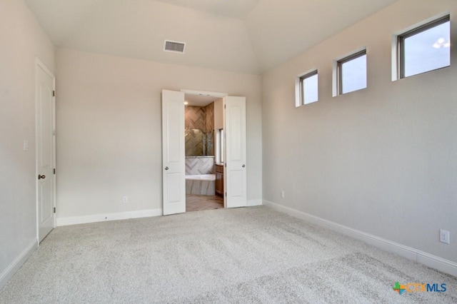 2023 Stephanie Ave, New Braunfels, TX 78132 - unfurnished bedroom with baseboards, carpet, lofted ceiling, and ensuite bath
