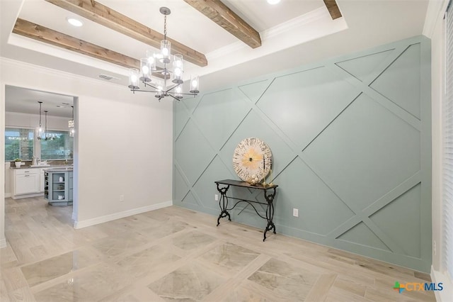 empty room featuring visible vents, a decorative wall, a notable chandelier, and beam ceiling