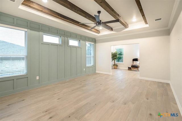 unfurnished room with a ceiling fan, visible vents, beam ceiling, and light wood-type flooring