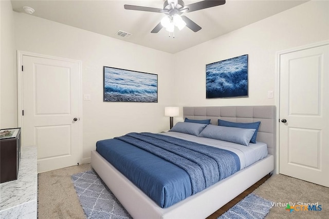 carpeted bedroom featuring ceiling fan and visible vents