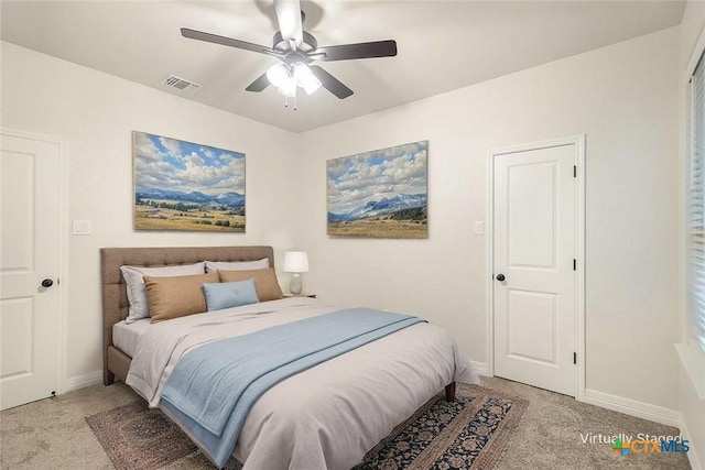 bedroom featuring a ceiling fan, baseboards, visible vents, and light carpet