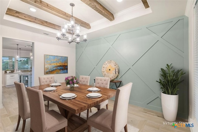 dining area featuring beamed ceiling, a decorative wall, light wood finished floors, and a chandelier