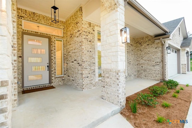 property entrance with a porch and brick siding