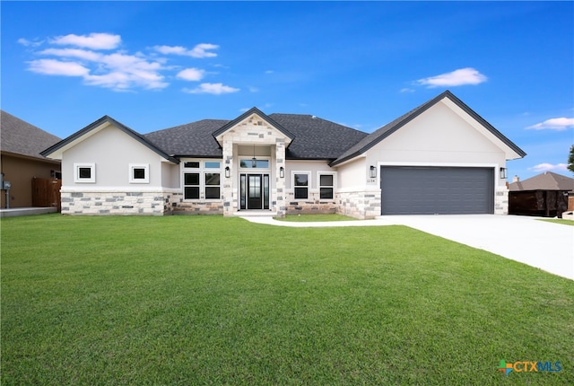 view of front of property featuring a garage and a front yard