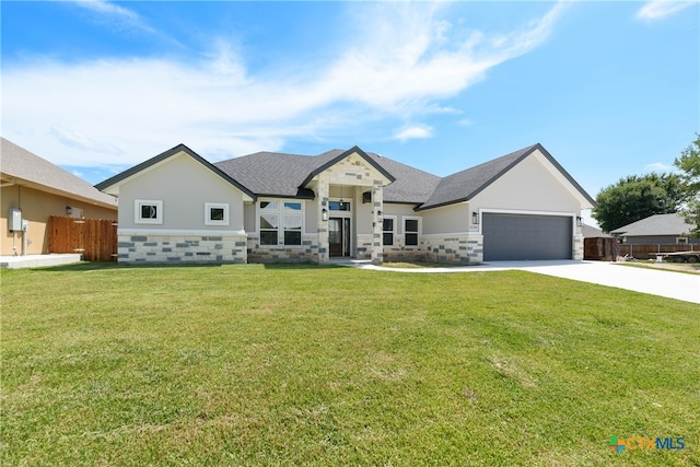 view of front of home featuring a garage and a front yard