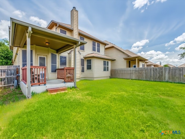 back of house with a lawn and a porch