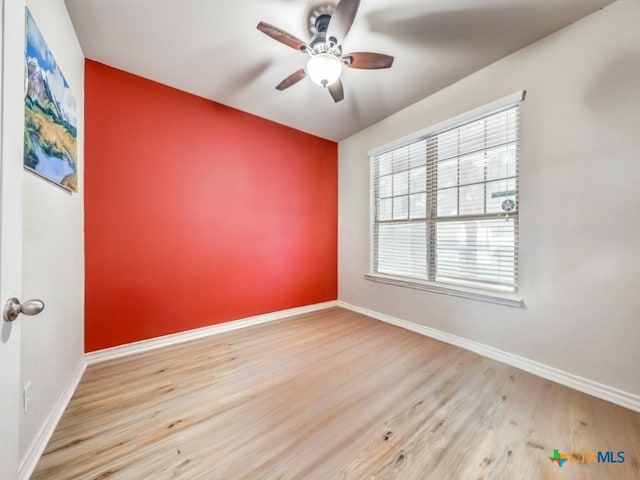 spare room with ceiling fan and light hardwood / wood-style flooring