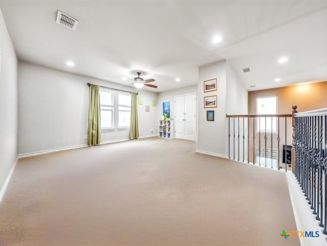 unfurnished room featuring ceiling fan and carpet