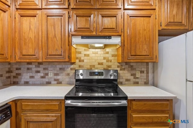 3927 Amanda Dr, Salado, TX 76571 - kitchen featuring white appliances, under cabinet range hood, light countertops, brown cabinetry, and tasteful backsplash