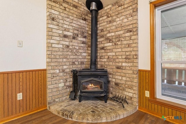 3927 Amanda Dr, Salado, TX 76571 - detailed view of a wood stove, wood finished floors, wainscoting, and wood walls