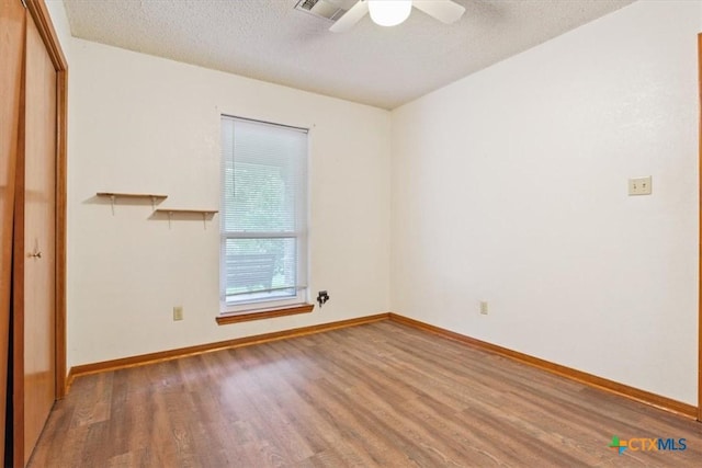 3927 Amanda Dr, Salado, TX 76571 - empty room featuring wood finished floors, ceiling fan, and a textured ceiling