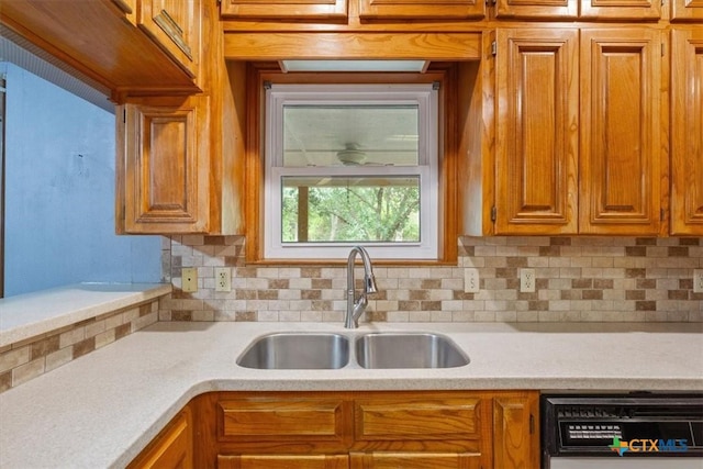 3927 Amanda Dr, Salado, TX 76571 - kitchen with dishwashing machine, backsplash, light countertops, and brown cabinetry