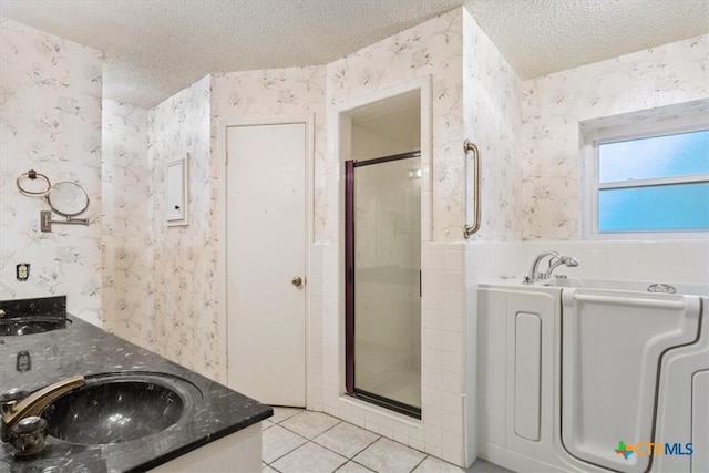 3927 Amanda Dr, Salado, TX 76571 - full bath with wallpapered walls, a textured ceiling, a stall shower, a bath, and tile patterned floors