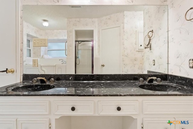 3927 Amanda Dr, Salado, TX 76571 - bathroom featuring wallpapered walls, double vanity, and a shower stall