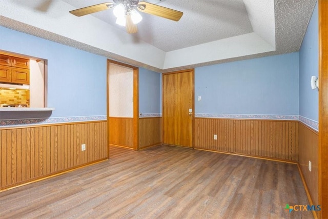 3927 Amanda Dr, Salado, TX 76571 - unfurnished room featuring a wainscoted wall, a textured ceiling, wood finished floors, and a ceiling fan