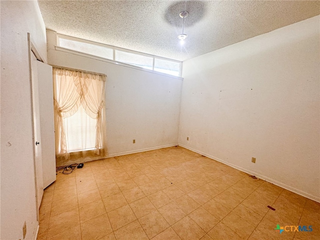 spare room featuring a textured ceiling