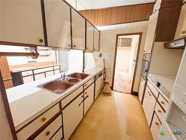 kitchen featuring white cabinetry, sink, and oven