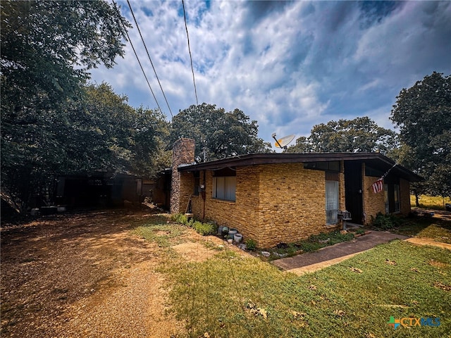 view of property exterior with a lawn