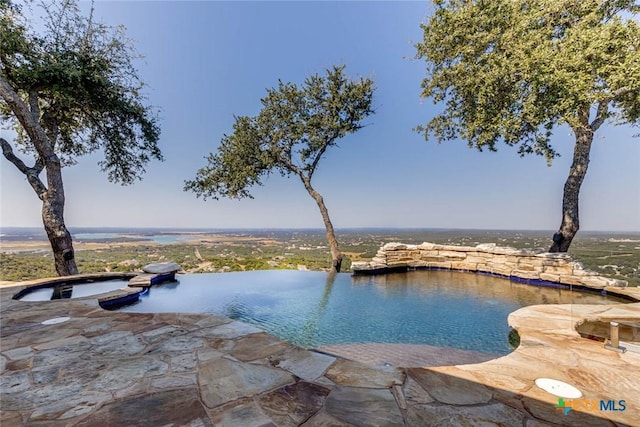 view of swimming pool with a water view