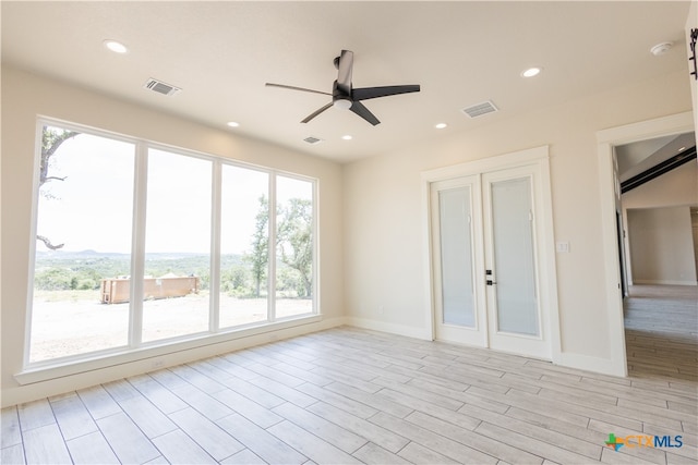 spare room featuring ceiling fan and light hardwood / wood-style floors