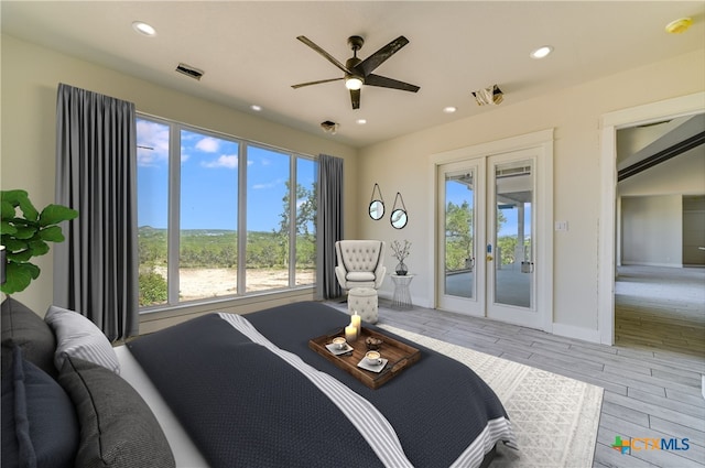 bedroom with access to exterior, french doors, light hardwood / wood-style floors, and ceiling fan