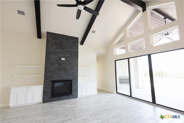 1193 Country Pike, Canyon Lake, TX 78133 - unfurnished living room with high vaulted ceiling, ceiling fan, beam ceiling, wood finished floors, and a glass covered fireplace