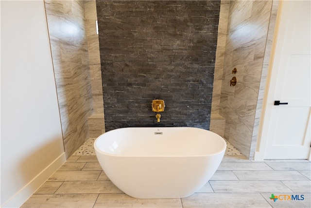 bathroom with a tub to relax in