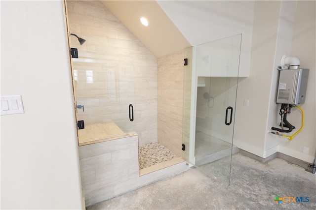 bathroom with concrete flooring, a shower with shower door, and vaulted ceiling