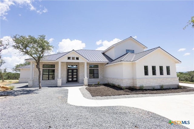 1193 Country Pike, Canyon Lake, TX 78133 - view of front of home with stone siding, a standing seam roof, stucco siding, and a metal roof
