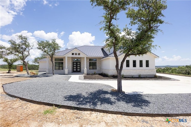 1193 Country Pike, Canyon Lake, TX 78133 - view of front of home featuring stone siding, french doors, a standing seam roof, and a metal roof