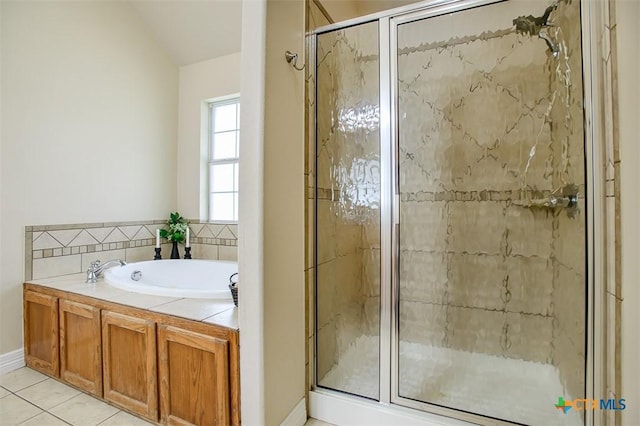 1127 Chaucer Ln, Harker Heights, TX 76548 - full bathroom featuring a stall shower, a garden tub, tile patterned floors, and vaulted ceiling