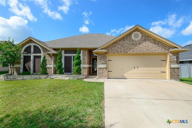 1127 Chaucer Ln, Harker Heights, TX 76548 - view of front of house with brick siding, a garage, concrete driveway, and a front yard