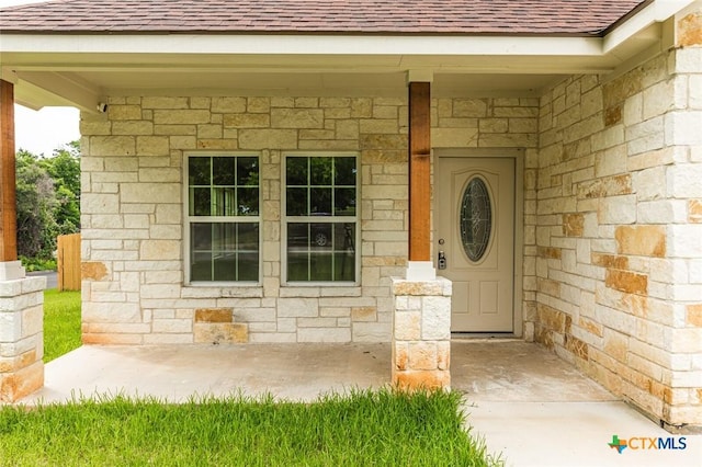 1700 Proctor Ave, Waco, TX 76708 - view of exterior entry with a shingled roof and stone siding