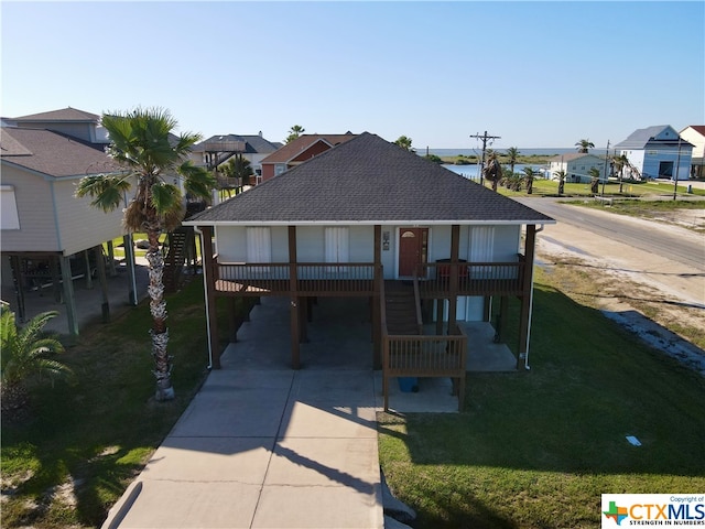 view of front facade with a carport and a front lawn