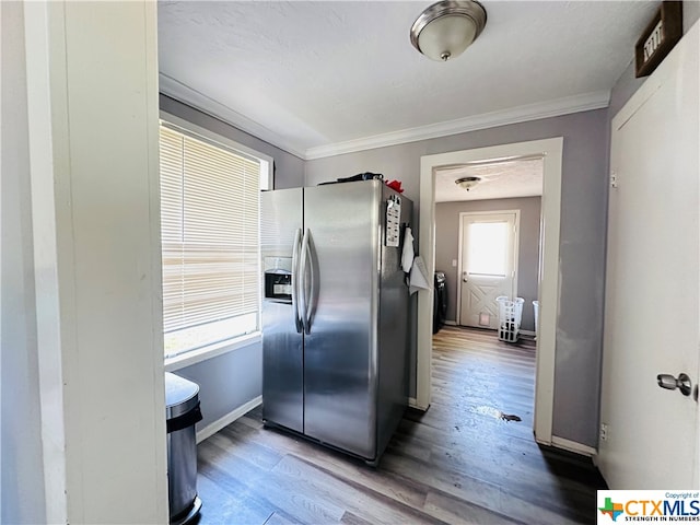 kitchen featuring hardwood / wood-style floors, stainless steel fridge with ice dispenser, and ornamental molding