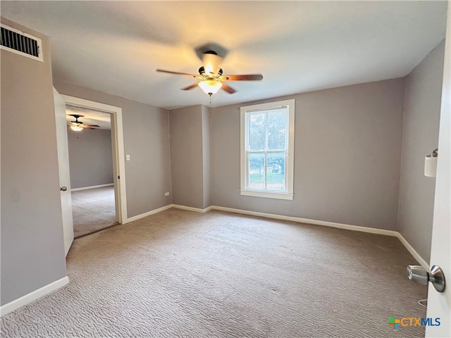 unfurnished room with ceiling fan and light carpet