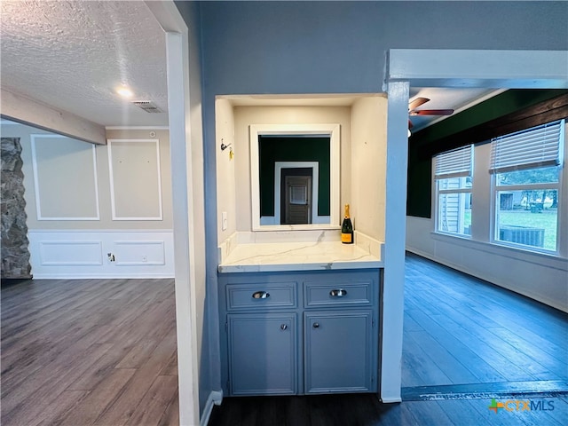 bathroom with vanity, wood-type flooring, and a textured ceiling