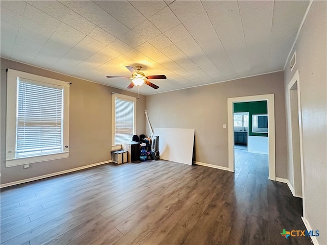 unfurnished room with ceiling fan and dark hardwood / wood-style flooring