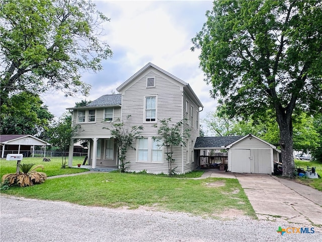 view of front of home featuring a front lawn and a storage shed