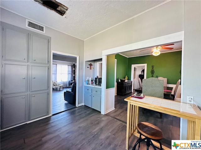 office with dark hardwood / wood-style flooring, a textured ceiling, and ceiling fan