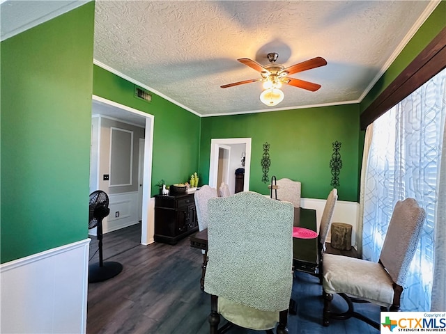 dining space with ornamental molding, ceiling fan, a textured ceiling, and dark hardwood / wood-style floors