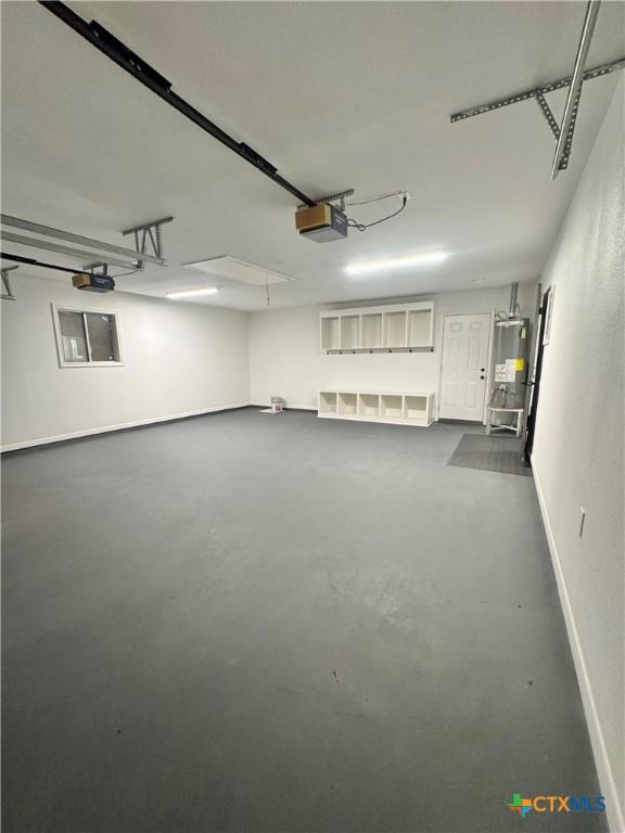 2704 Loma Vista Ave, Victoria, TX 77901 - garage featuring a garage door opener and gas water heater