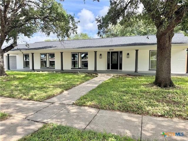 2704 Loma Vista Ave, Victoria, TX 77901 - single story home with a front lawn, brick siding, a porch, and roof with shingles