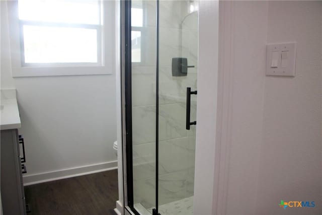 2704 Loma Vista Ave, Victoria, TX 77901 - bathroom with vanity, a marble finish shower, and wood finished floors