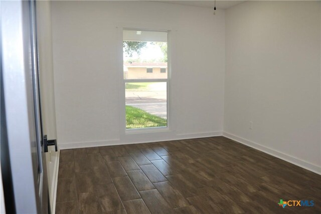 2704 Loma Vista Ave, Victoria, TX 77901 - empty room featuring dark wood-type flooring and baseboards
