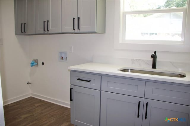 2704 Loma Vista Ave, Victoria, TX 77901 - laundry area featuring hookup for a washing machine, cabinet space, and dark wood-type flooring