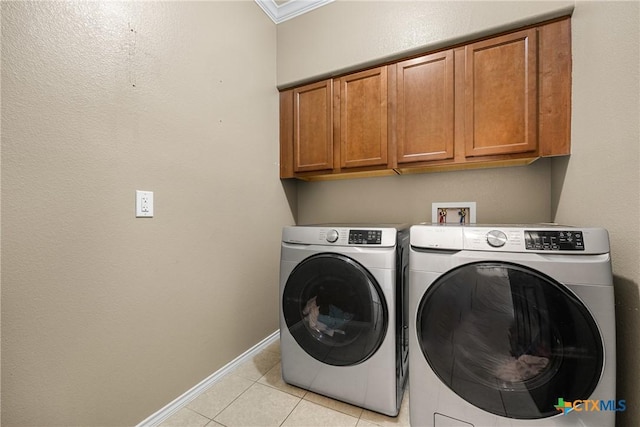 1103 Sugar Brook Dr, Temple, TX 76502 - washroom with cabinet space, washing machine and clothes dryer, and light tile patterned floors