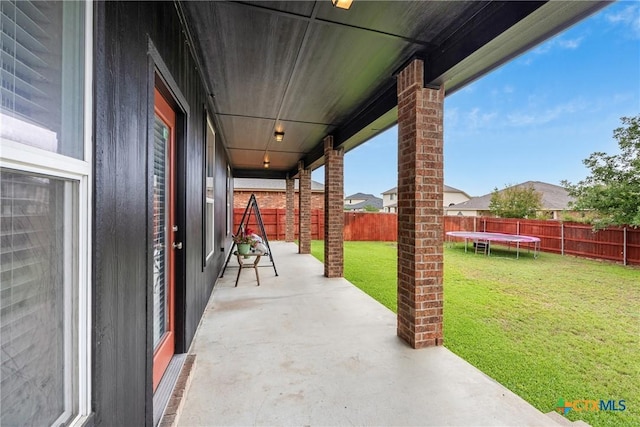 1103 Sugar Brook Dr, Temple, TX 76502 - fenced backyard with a trampoline and a patio area