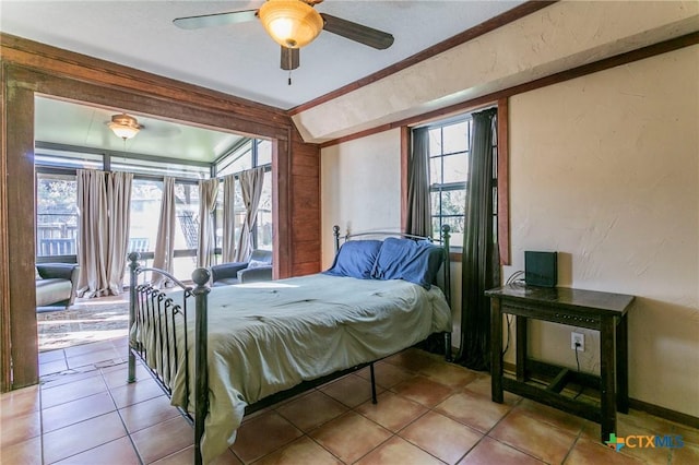 bedroom featuring multiple windows, ceiling fan, light tile patterned flooring, and vaulted ceiling