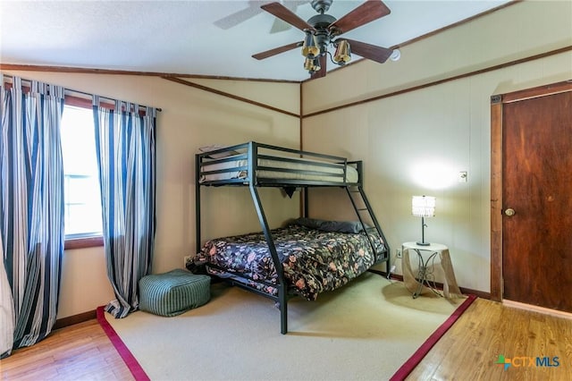 bedroom with hardwood / wood-style flooring, ceiling fan, and lofted ceiling